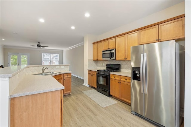 3382 Galleon Dr, Alpharetta, GA 30004 - kitchen featuring appliances with stainless steel finishes, a sink, light wood finished floors, decorative backsplash, and recessed lighting