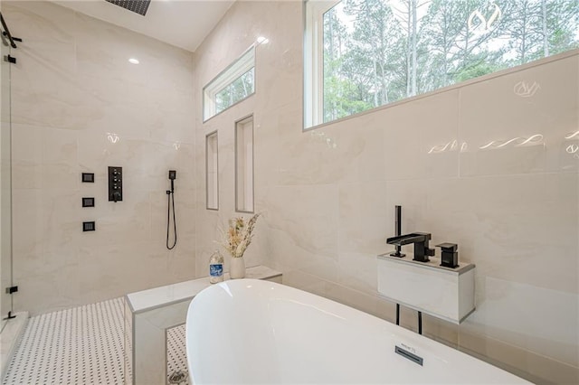1273 Grayson Pkwy, Grayson, GA 30017 - full bath featuring tile walls, a soaking tub, and tiled shower