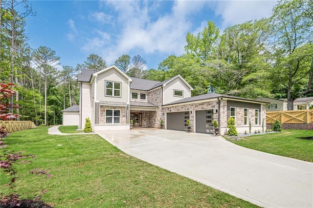 1273 Grayson Pkwy, Grayson, GA 30017 - view of front of home featuring driveway, stone siding, a garage, and a standing seam roof