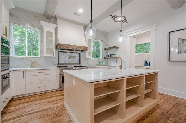 1273 Grayson Pkwy, Grayson, GA 30017 - kitchen with open shelves, custom range hood, stainless steel range, decorative backsplash, and light wood-style flooring