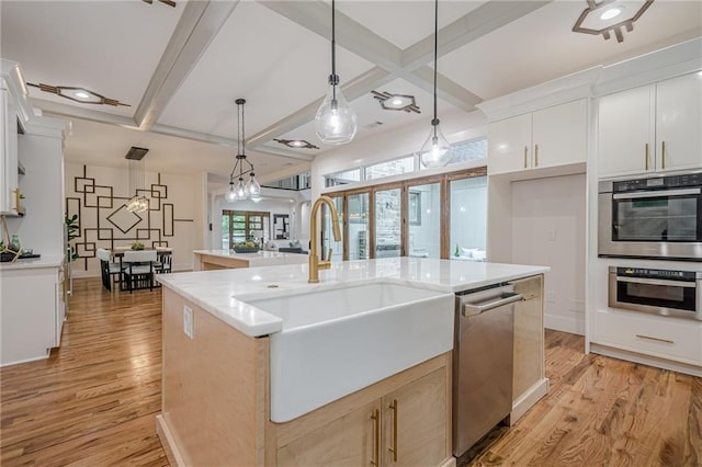 1273 Grayson Pkwy, Grayson, GA 30017 - kitchen featuring a sink, appliances with stainless steel finishes, coffered ceiling, light wood-style floors, and light countertops