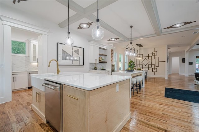 1273 Grayson Pkwy, Grayson, GA 30017 - kitchen featuring a sink, a kitchen island with sink, open shelves, light wood finished floors, and beam ceiling
