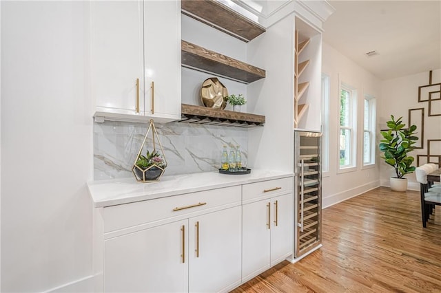 1273 Grayson Pkwy, Grayson, GA 30017 - indoor dry bar with backsplash, light wood-style floors, and baseboards
