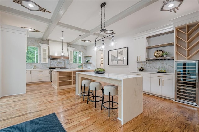 1273 Grayson Pkwy, Grayson, GA 30017 - kitchen with open shelves, wine cooler, a center island, premium range hood, and coffered ceiling