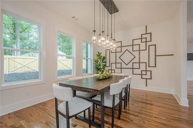1273 Grayson Pkwy, Grayson, GA 30017 - dining room with baseboards, wood finished floors, and a chandelier