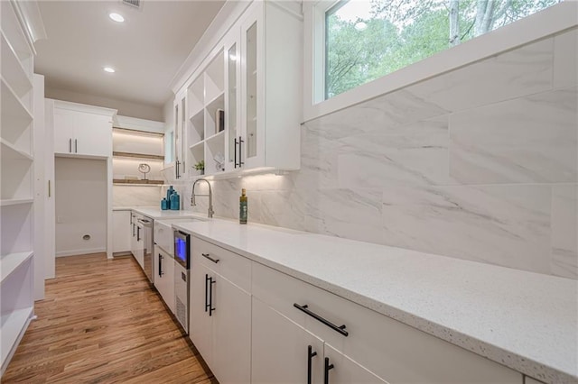 1273 Grayson Pkwy, Grayson, GA 30017 - kitchen with open shelves, tasteful backsplash, white cabinetry, light wood finished floors, and recessed lighting