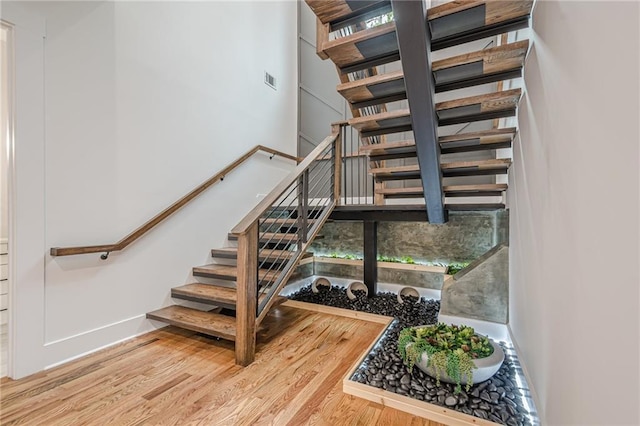 1273 Grayson Pkwy, Grayson, GA 30017 - stairway with wood finished floors, a high ceiling, and baseboards