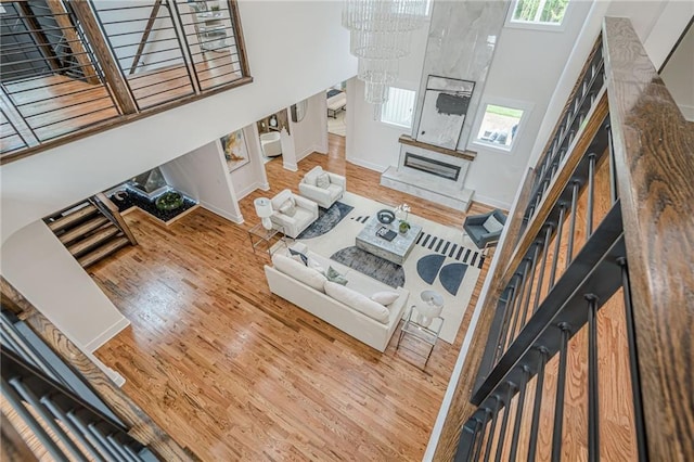 1273 Grayson Pkwy, Grayson, GA 30017 - living area with wood finished floors, plenty of natural light, a glass covered fireplace, and a towering ceiling