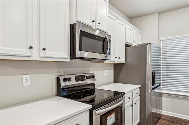 2111 Wesson Ct, Kennesaw, GA 30144 - kitchen featuring appliances with stainless steel finishes, white cabinets, light stone counters, and dark wood-style flooring
