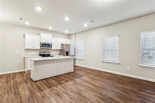 2111 Wesson Ct, Kennesaw, GA 30144 - kitchen with appliances with stainless steel finishes, a center island with sink, dark wood-style floors, baseboards, and recessed lighting