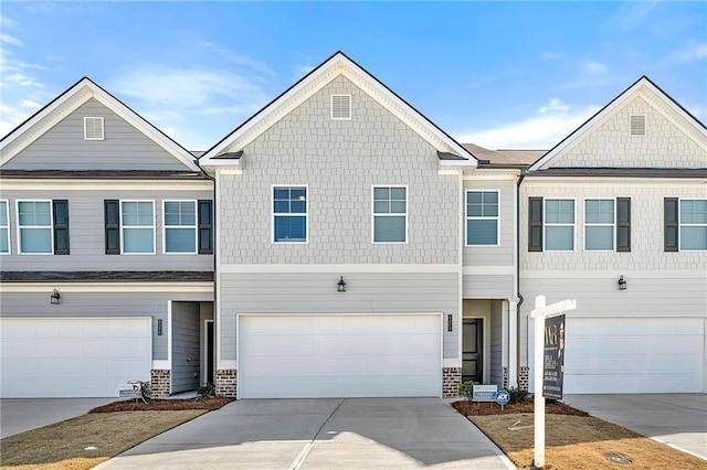 multi unit property featuring driveway and an attached garage