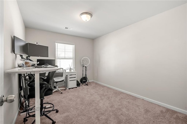 office featuring baseboards, visible vents, and carpet flooring