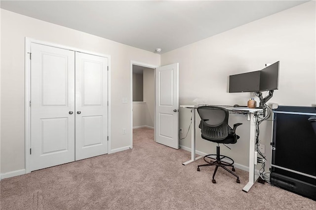 carpeted home office featuring baseboards