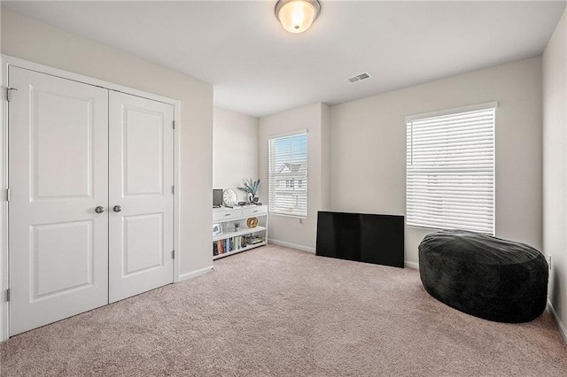 miscellaneous room featuring carpet flooring, visible vents, and baseboards