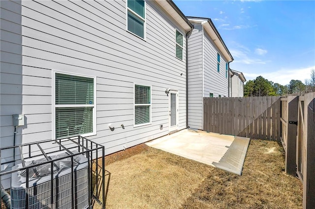 back of house featuring a yard, a patio area, fence, and central air condition unit