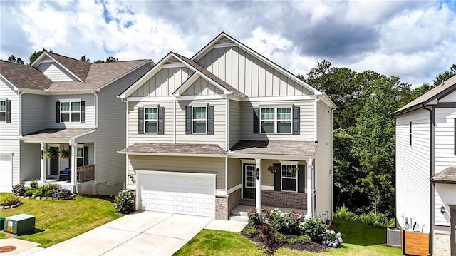 56 Preserve Pt, Jasper, GA 30143 - view of front of home featuring board and batten siding, covered porch, a front yard, and brick siding