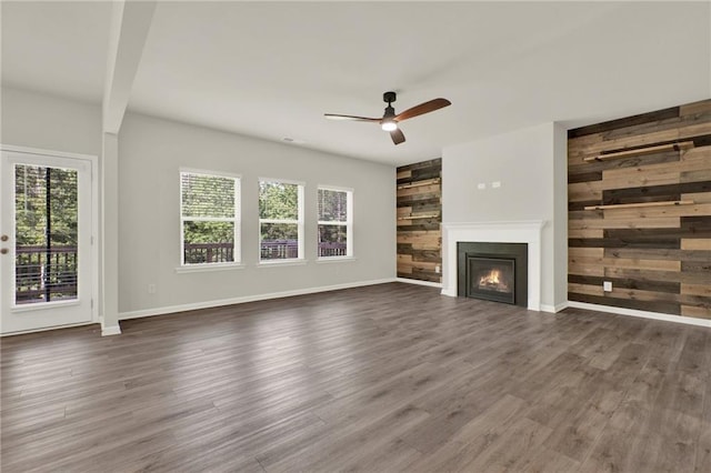 56 Preserve Pt, Jasper, GA 30143 - unfurnished living room featuring a glass covered fireplace, ceiling fan, wood finished floors, and wood walls