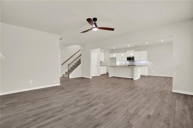 56 Preserve Pt, Jasper, GA 30143 - unfurnished living room with dark wood-type flooring, stairway, ceiling fan, and recessed lighting