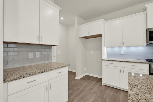 56 Preserve Pt, Jasper, GA 30143 - kitchen featuring light wood-style floors, white cabinetry, light stone counters, stainless steel appliances, and recessed lighting