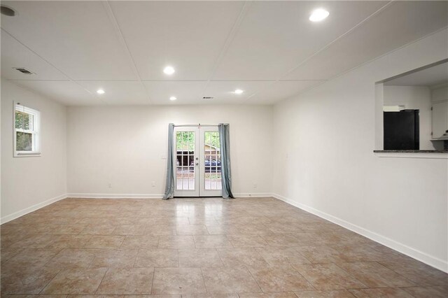 spare room featuring baseboards, recessed lighting, visible vents, and french doors