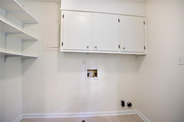 laundry area with light tile patterned floors, electric panel, baseboards, hookup for a washing machine, and cabinet space