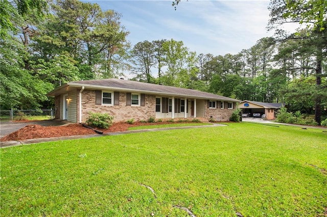 ranch-style house with aphalt driveway, fence, a front yard, and brick siding