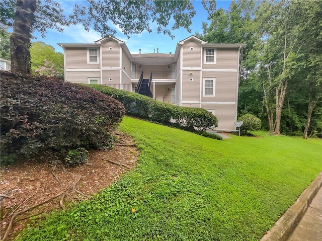 rear view of house with a lawn