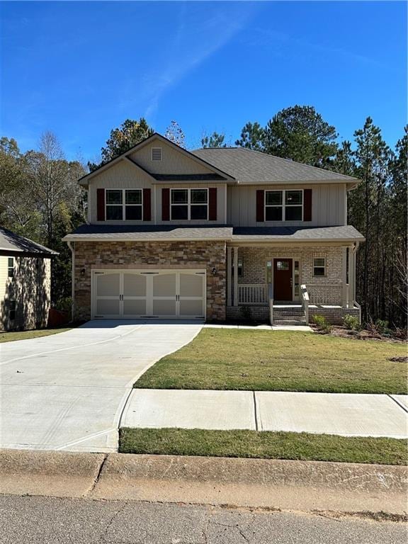 view of front of home featuring a porch, a garage, and a front yard