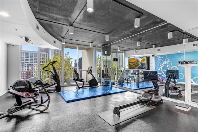 workout area featuring floor to ceiling windows and visible vents