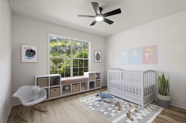 3765 Michaels Way, Cumming, GA 30040 - bedroom featuring a crib, baseboards, and wood finished floors