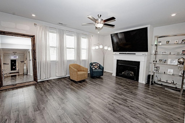 unfurnished room with ceiling fan, recessed lighting, a fireplace, wood finished floors, and visible vents