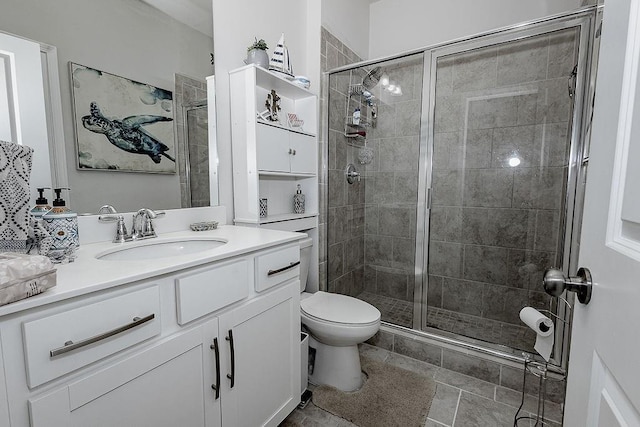 bathroom with toilet, a stall shower, and vanity