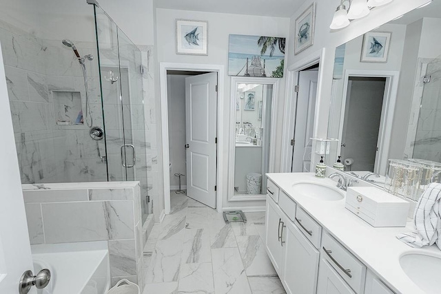 bathroom with double vanity, a stall shower, marble finish floor, a washtub, and a sink