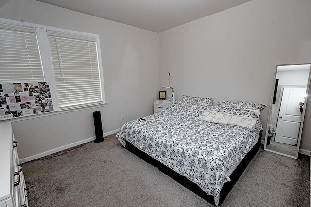 carpeted bedroom featuring baseboards