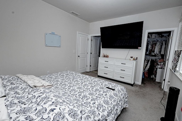 bedroom with carpet floors, a closet, a walk in closet, and visible vents