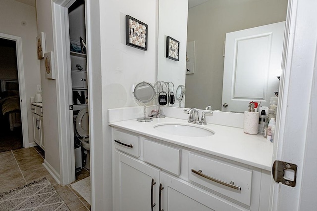 bathroom featuring toilet, tile patterned floors, and vanity