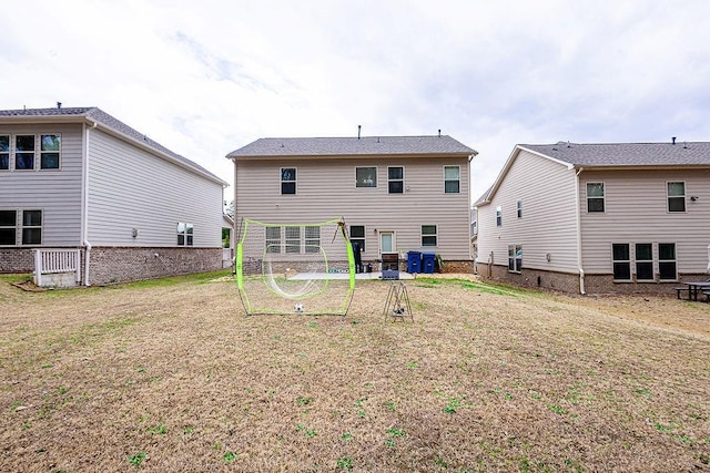 back of property with a lawn