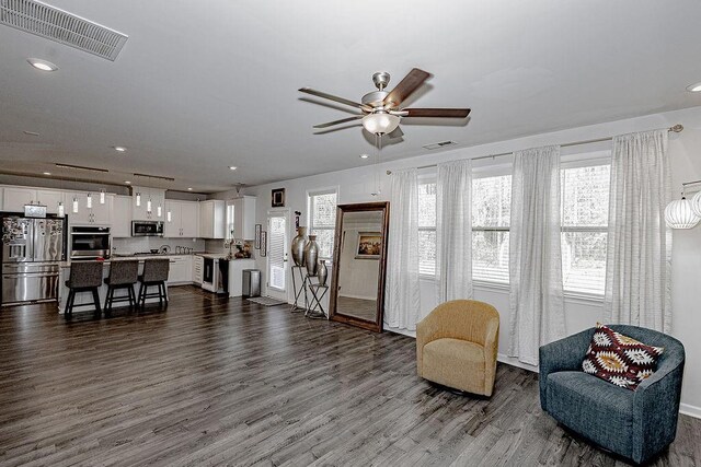 kitchen with light stone counters, white cabinetry, sink, and appliances with stainless steel finishes