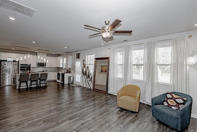 interior space featuring ceiling fan, dark wood finished floors, visible vents, and recessed lighting