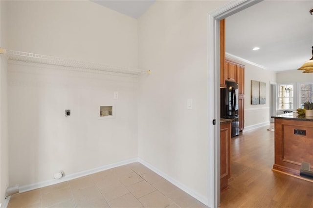 laundry area with hookup for a washing machine, hookup for an electric dryer, and light hardwood / wood-style flooring