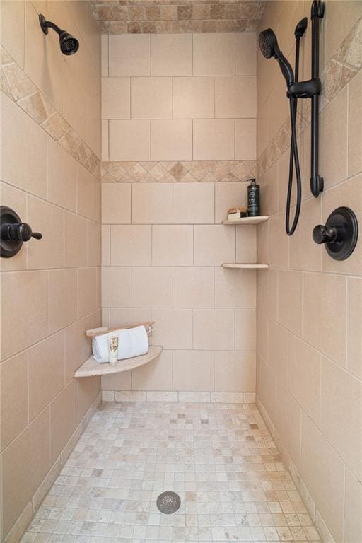 bathroom with a tile shower