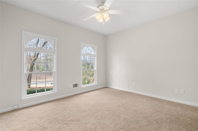 unfurnished room featuring ceiling fan and carpet flooring