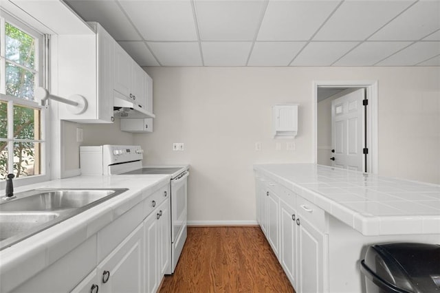 kitchen with dark hardwood / wood-style flooring, a paneled ceiling, white cabinets, and white range with electric stovetop