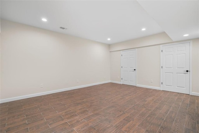 basement with dark hardwood / wood-style floors