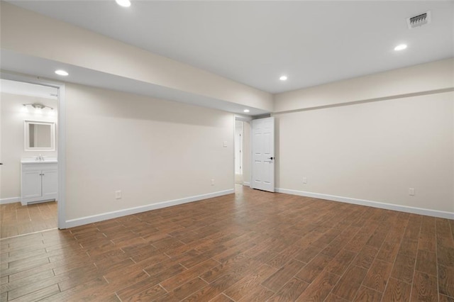 basement with sink and dark hardwood / wood-style floors