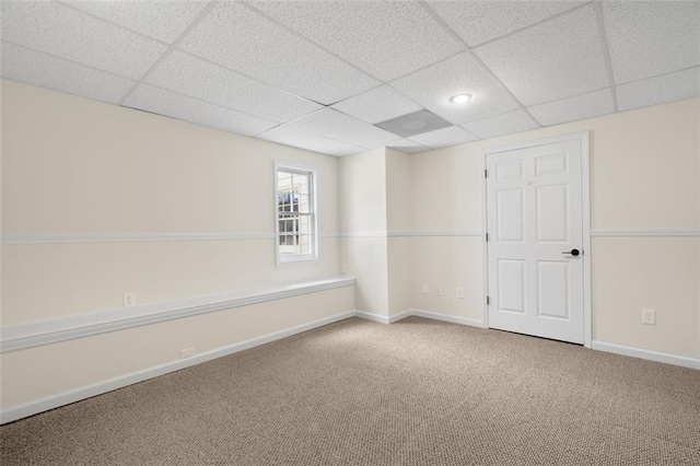 spare room with a drop ceiling and carpet flooring