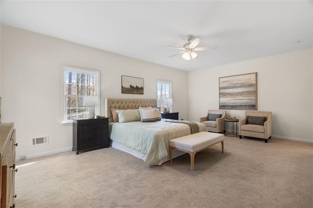 bedroom with ceiling fan and light carpet