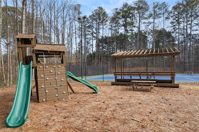 view of play area featuring tennis court