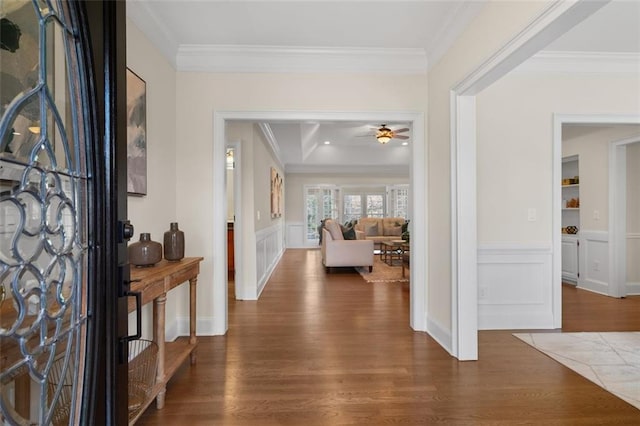 entrance foyer featuring ornamental molding, dark hardwood / wood-style floors, and ceiling fan