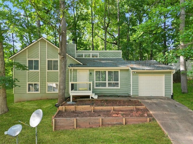 split level home with a front yard and a garage